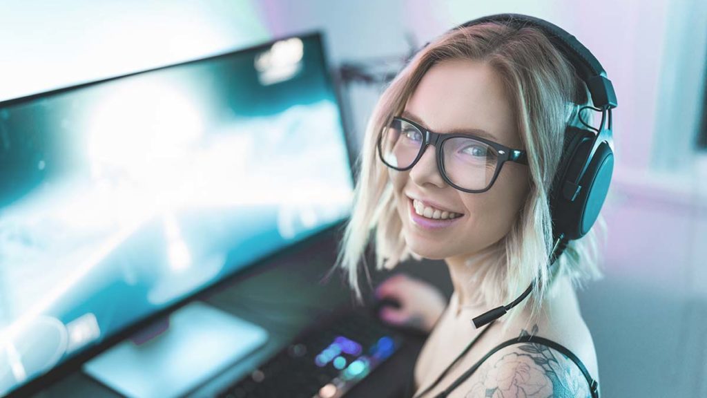 girl in headphones working on computer
