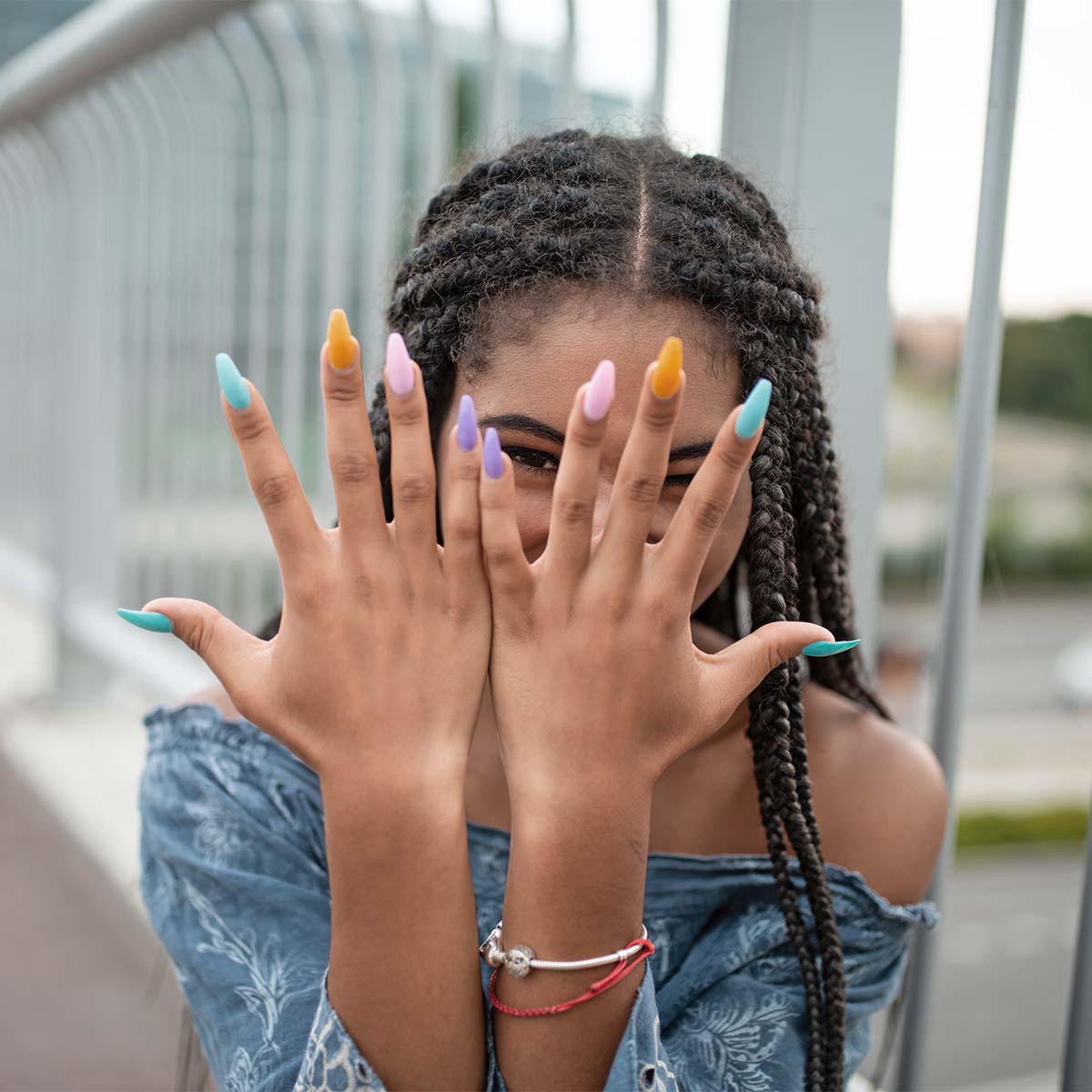 girl showing her colourful nails
