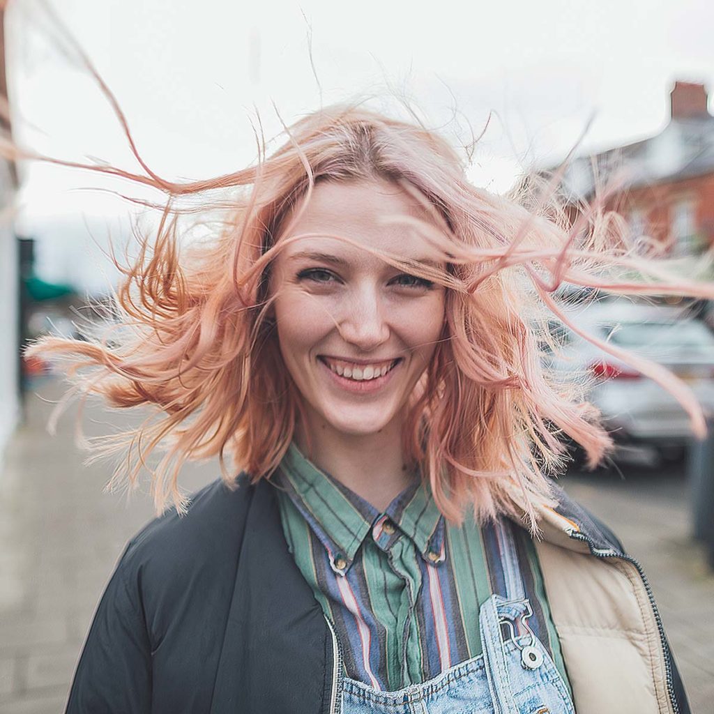 woman smiling with hair blowing in the wind